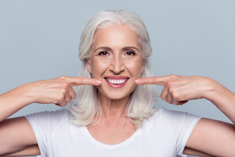 A woman smiling and showing off her smile